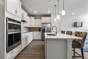 The kitchen island provides additional counter space for serving snacks or meals