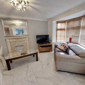 Bright clean living room with patio doors to the garden. 