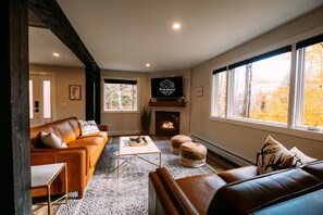 1st Floor Living Space with leather seating, tv and fireplace.