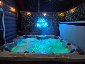 Unwind in our cozy hot tub, set against the glow of a vibrant neon sign. Whether you're relaxing under the stars or enjoying the soft ambiance, it's the perfect spot to chill out and recharge.