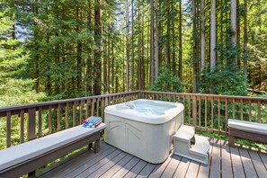 Soak in the hot tub surround by redwoods.