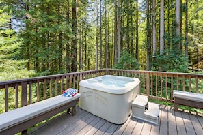 Soak in the hot tub surround by redwoods.
