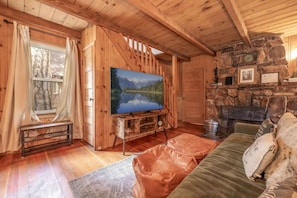 The living room has a charming rock fireplace.