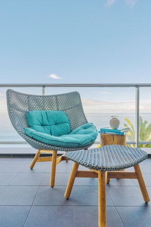 Luxuriate in our woven cocoon chair, a perfect nook for relaxation amidst the expansive sea views