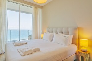 Awake to the sight of the ocean in a king-size bed, where comfort meets the horizon