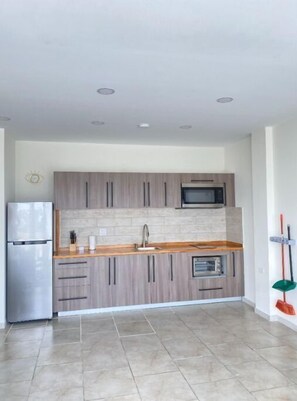 Fully equipped Kitchen with electric stove and amenities.