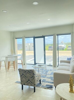 Fully equipped living room with AC and Smart TV.