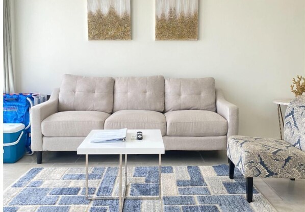 Fully equipped living room with AC and Smart TV.