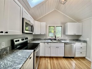 Newly renovated kitchen overlooks spacious backyard