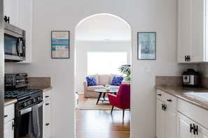 Kitchen peeking into the living room