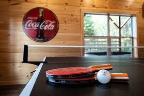 The game room has ping-pong and a custom billiards table ready for play.