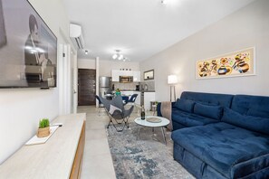 Living room with smart TV and balcony view.