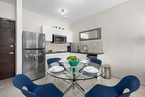 A fully equipped kitchen with modern appliances and a stylish dining area.