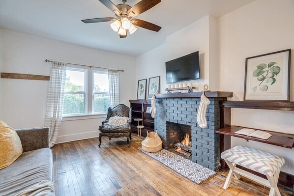 Living room with double-pane windows, gas fireplace, and smart TV