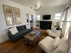 Quaint living room with gas fireplace, smart TV, and plenty of comfortable seating