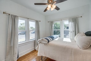 The primary bedroom has new double-pane windows to reduce street noise. The room is filled with natural light during the day, and blackout curtains provide a peaceful night's sleep.