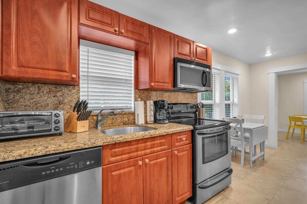 Unleash your inner chef in our newly renovated kitchen, thoughtfully equipped with the essentials, a spacious full-size refrigerator, and an abundance of storage spaces.