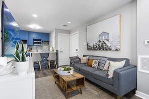 Sofa, coffee table, fast wi-fi,Smart TV, Modern Art, and Central Air Conditioning in the Living Room.
