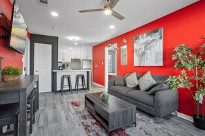 Sofa Bed, Smart TV, Modern Art, and Central Air Conditioning in the Living Room.