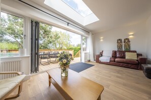 Ground floor: More comfortable seating, with large bi-folds that take you out onto the rear garden and decking