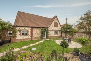 York Cottage, Thornham: Enclosed rear garden with bistro set and mature planting
