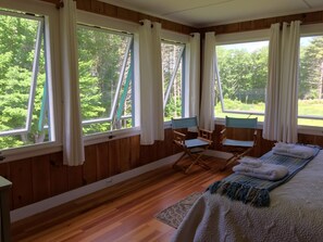 The 2nd floor NW Master Bedroom windows let in cross breeze & nature's symphony.