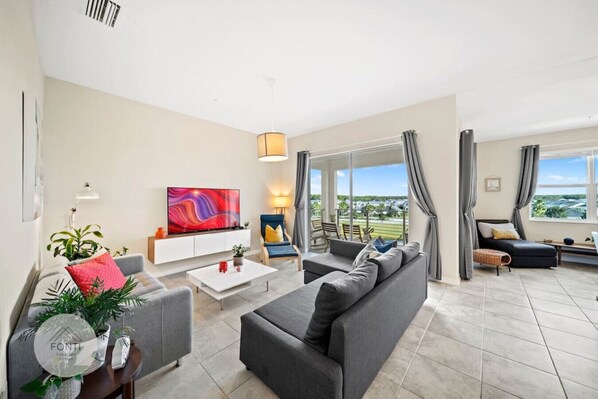 Living Room with 65" Smart TV#Disney #Parks #kingdom #springs #StoreyLake #resort #Apartment #Vacation #Rental #waterpark #Kissimmee #Orlando #universal #citywalk