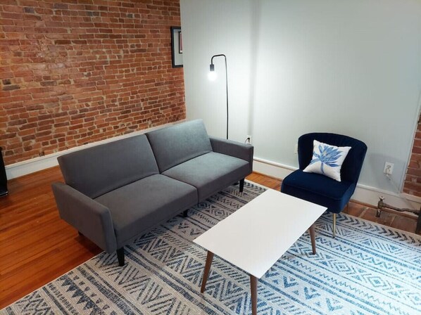 Cozy living area with beautiful exposed brick.