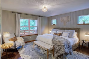 Primary Bedroom with king size bed and cozy reading chair