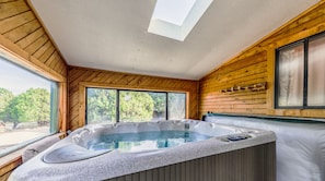 Hot tub is located in enclosed sun room