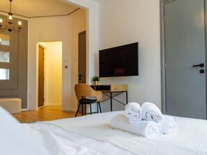 Working desk in the living room/bedroom with smart TV, WiFi, AC, cotton linens and towels