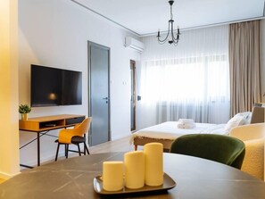 Large studio living room/bedroom with working desk, dining table for 2, access to balcony, AC, cotton linens, fluffy towels and electric exterior blinds 