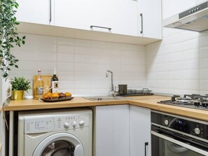 Fully equipped kitchen with refrigerator, microwave, stove, oven, coffee machine and washer 