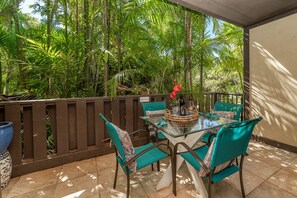 Lanai with lush garden surroundings