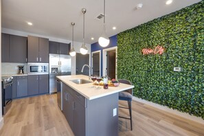 Fully equipped kitchen stocked with your basic cooking essentials, stainless steel appliances, and breakfast bar seating.