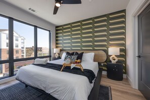 Primary bedroom with King bed, smart TV, large walk-in closet, and ensuite bathroom with walk-in shower.