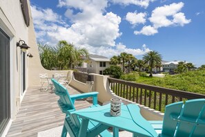 This quiet balcony is off the living and master space upstairs and overlooks an empty lot looking toward the beach.