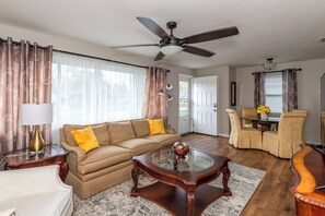 Classy living and dining area, hardwood flooring.  55 inch Roku Smart TV, High Speed Wi-fi.  