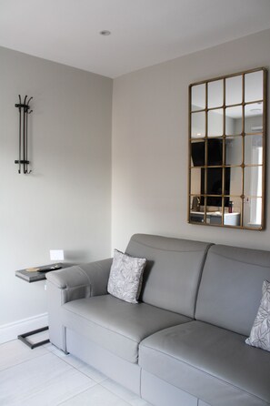 Living area with double sofa bed and flat screen television