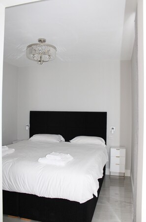 Bedroom with Super King bed, flat screen television and hanging racks