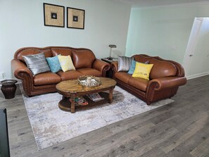 Living room 2 with comfy leather chairs, a 65'inch UHD Smart TV, plus more. 