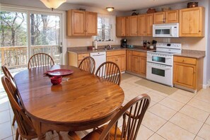 Large kitchen is fully appointed. Imagine the fun preparing food, or the card game around this table