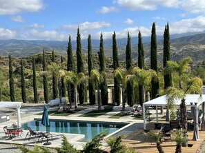 Embrace tranquility where azure waters meet majestic mountains; a paradise touched by the whispers of palm and cypress trees. This isn't just a saltwater pool, it's a serene escape into nature's luxury lounge.