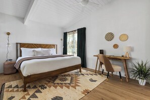 Bedroom with a king size bed and dedicated workspace.
