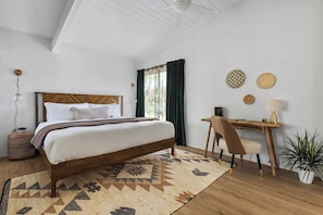 Bedroom with a king size bed and dedicated workspace.