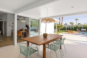 Outdoor dining area under a covered patio to stay cool in the Palm Springs heat.