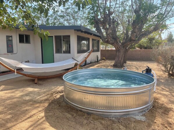 Escape the desert heat in the shaded cowboy pool and relaxing hammock