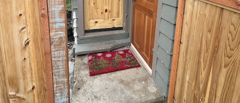 Entrance to cottage, fully fenced and gated. Laundry room is also pictured.