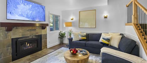 Cozy Living Room with Fireplace and Big Screen TV