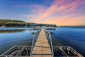 Private 4 slip dock. This dock features high dive + swim ladder. One Boat slip available to guests.